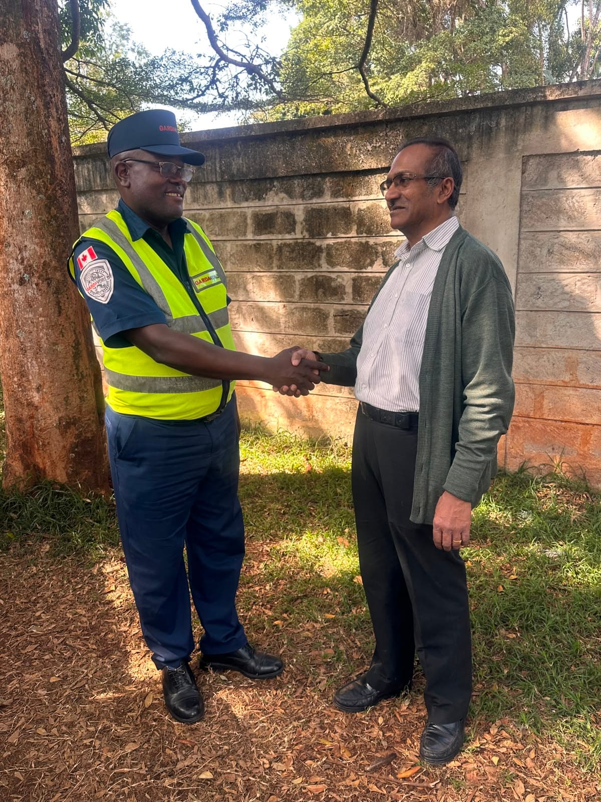 Bali Fashions team member handing over a finished uniform